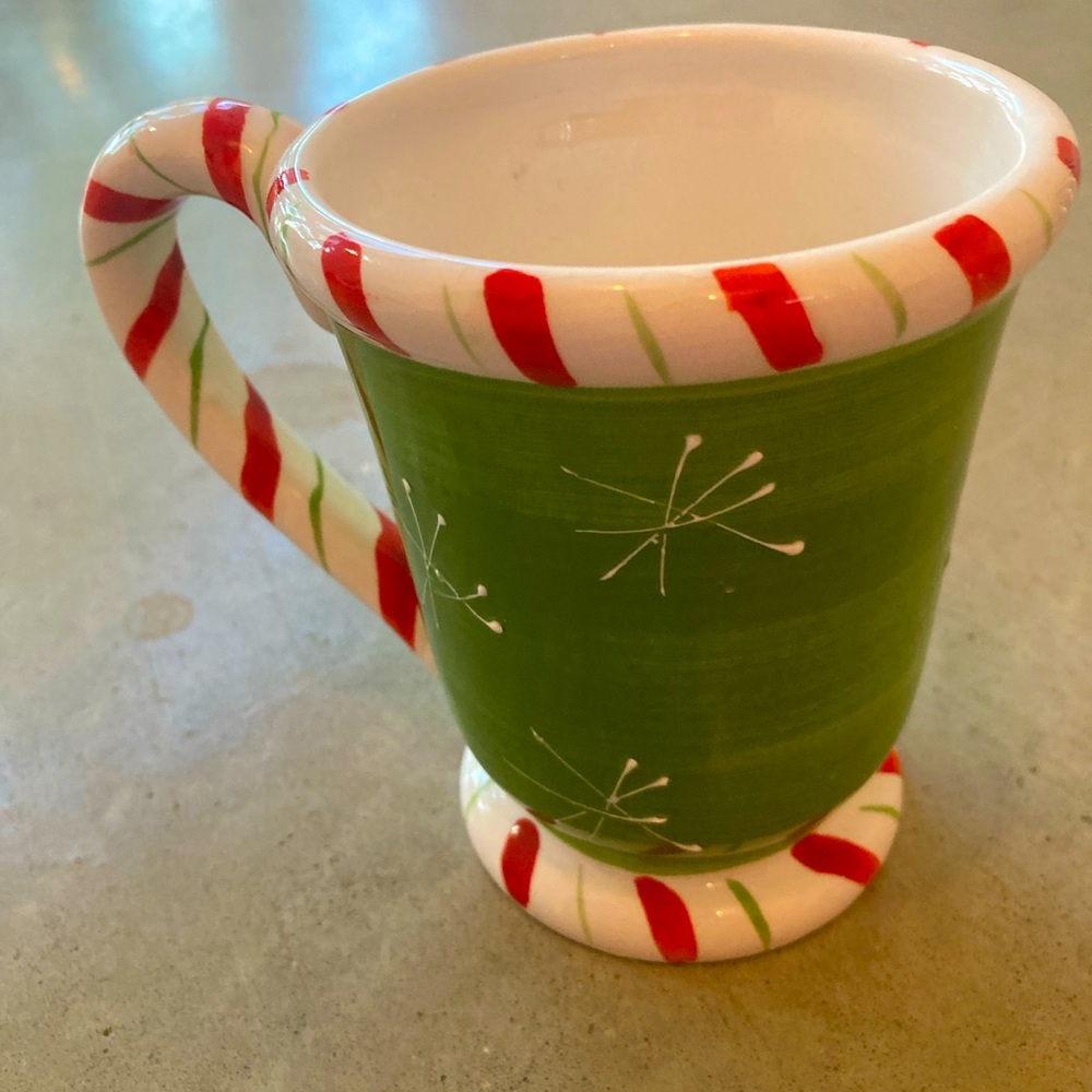 Cute Christmas ceramic mug with striped handle.